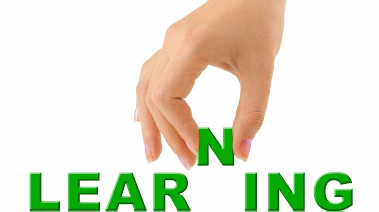 A hand places the letter 'N' between the green letters 'LEAR' and 'ING' to complete the word 'LEARNING.' Symbolizing the process of lifelong learning and continuous development.